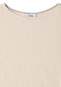 Haut en maille côtelée beige avec encolure ronde et étiquette de marque "CECIL" cousue à l'intérieur du col.
