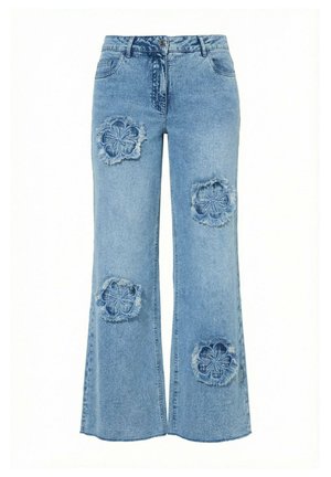 Light blue denim jeans with flared legs featuring four large frayed flower-shaped patches on front thighs and lower legs.