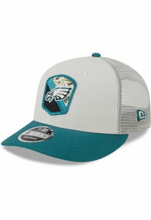 White snapback cap with a teal brim, mesh back, and an embroidered Philadelphia Eagles logo in a shield design with camouflage accents.