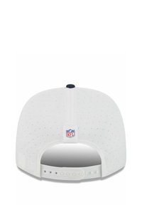 White adjustable snapback cap with small perforations and NFL logo patch at the back center below the button.