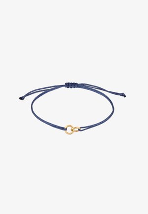 Tamsiai mėlynas virvės apyrankė su auksinės spalvos apvaliu centru ir reguliuojamais mazgais, leidžiančiais pritaikyti dydį.