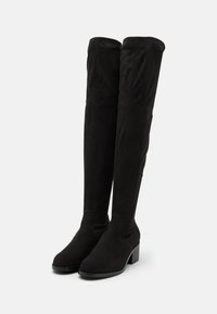 Black over-the-knee boots made of soft suede with a square heel, featuring a smooth texture and seamless design.