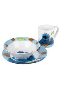 Set of ceramic dishware featuring Cookie Monster from Sesame Street. Includes a plate, bowl, and mug with blue and white colors, cookie designs.