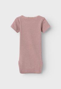 Ribbed, short-sleeve bodysuit in soft pink with a lace trim at the neckline and side pockets, emphasizing comfort and practicality.