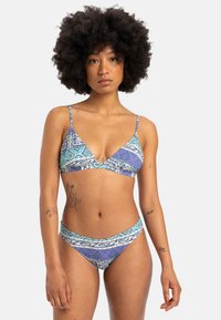 Bikini set with triangular top and matching bottoms. Features a geometric pattern in blue and purple tones, made from smooth material.