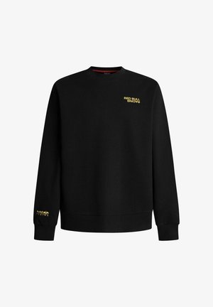 Μαύρο φούτερ με μακριά μανίκια, με κίτρινη επιγραφή «Red Bull Racing» στο στήθος και στον αριστερό καρπό, με ριμπ μανσέτες και τελείωμα.