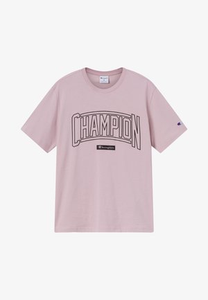 T-shirt rosa chiaro a maniche corte con grande scritta "CHAMPION" contornata e piccolo logo Champion sul petto e sulla manica.