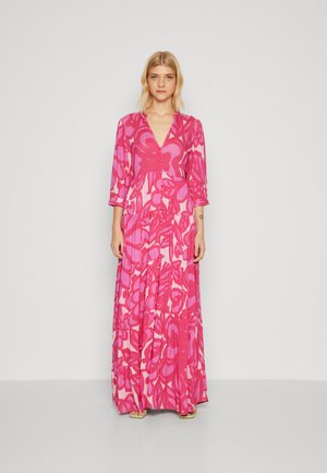 Long pink floral dress with deep V-neck, three-quarter sleeves, and tiered skirt design featuring bold pink and soft red patterns.