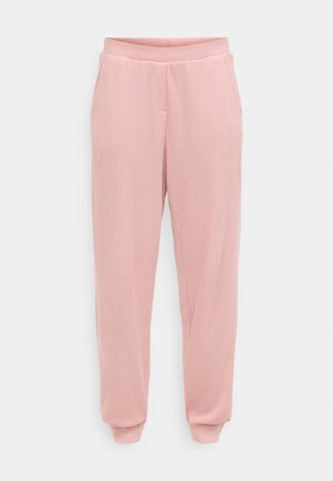 Pantalones jogger de color rosa claro hechos de tela texturizada, con cintura elástica, bolsillos laterales y ajuste cónico en el tobillo.