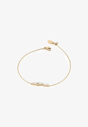 Bracelet en or comportant cinq cristaux transparents en forme d'étoile le long d'une chaîne délicate, avec une fermeture à fermoir crocodile et une longueur ajustable.