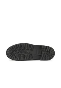 Black rubber sole with deep treads. Features a flat design, textured surface, and raised accents for traction and durability.