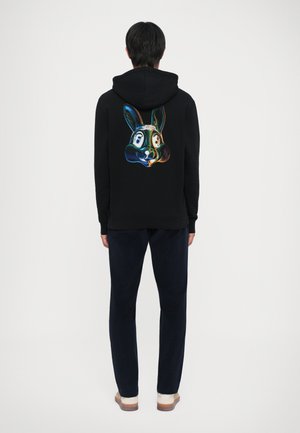 Schwarzer Hoodie mit grafischem, buntem Kaninchenmotiv auf dem Rücken. Strukturierter Stoff, lockere Passform, mit einer Kapuze mit Kordelzug und gerippten Bündchen.