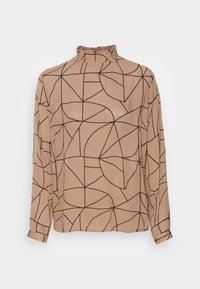 Blouse beige à manches longues présentant un col haut à volants, des motifs géométriques noirs et une texture légère et douce.