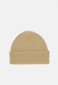 Knit beanie in light beige, featuring ribbed texture and a folded cuff at the base. Simple, seamless design with a rounded top.