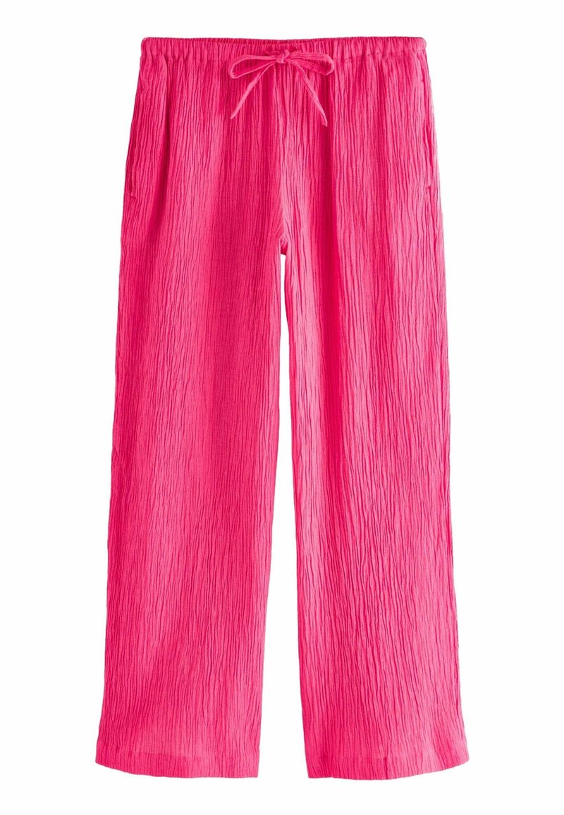 Pantalon rose vif à jambes larges avec une texture froissée et une taille élastique dotée d'un cordon noué à l'avant.