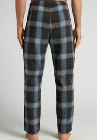Rutig flanellbyxor med svart och blå rutmönster, elastisk midja, raka ben och en mjuk textur.