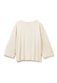 Beige Langarmshirt mit lockerer Passform und Rundhalsausschnitt, von hinten auf einem weißen Hintergrund gezeigt.