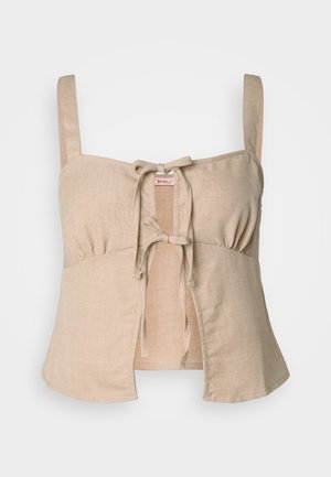 Beige linen cropped top with thin straps and a front tie closure. Features gathered detailing and a flared hem. Smooth texture.
