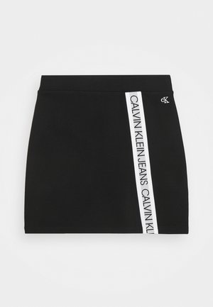 Czarna mini spódnica z białym, pionowym paskiem z boku z napisem "Calvin Klein Jeans" oraz małym logo "cK" blisko talii.