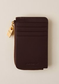 Brown leather wallet with zip closure, featuring multiple card slots and a metal charm. Smooth texture with stitched edges. Brand embossed.