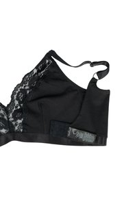 Black bralette featuring lace detailing on one side, soft fabric, adjustable straps, and a hook-and-loop closure with care label on the side.