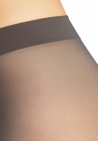 Przezroczyste rajstopy o gładkim, matowym wykończeniu. Ciemnoszary pas z subtelną fakturą. Część główna ma przezroczysty, jasnobrązowy odcień.