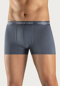 Gray boxer briefs with a soft texture, fitted design, and a wide elastic waistband featuring "COPENHAGEN STUDIOS" in white lettering.