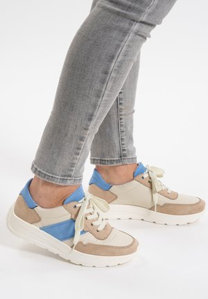 Beige and blue sneakers with suede and mesh material, featuring a round toe, padded collar, and cream laces. Textured rubber sole.
