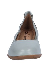 Light blue leather flats with a rounded toe, cut-out sides, and a tan rubber sole. The interior features a beige lining.