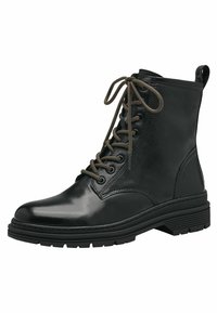 Bottines en cuir noir avec bout rond, lacets à l'avant et lacets en bronze. Semelle en caoutchouc épaisse avec un motif de traction et une languette à l'arrière.