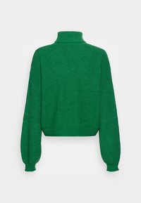 Vihreä neulottu neule, jossa on korkea kaulus, lyhyt pituus ja ylisuurikätiset hihat. Kankaan pinta on teksturoitu ja pehmeä. Ei näkyviä kuvioita tai korostuksia.