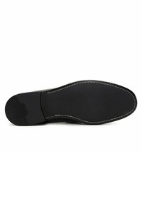 Black shoe sole with a textured surface, rounded toe, and contrasting white stitching along the edge. Durable rubber material.