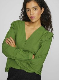 Green button-up blouse featuring a V-neckline, long sleeves with gathered cuffs, and ruffled accents on the shoulders in a textured fabric.