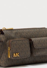 Mala castanha texturada com fecho dourado e dois bolsos frontais, um com o logótipo dourado "MK".