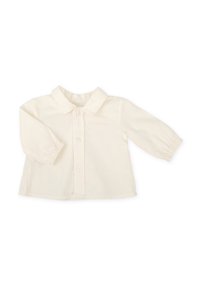 Camisa de manga larga color crema con collar clásico, cierre de botones y puños fruncidos. Fabricada con una suave tela texturizada con costuras sutiles.