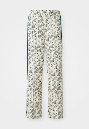 Patterned pants in cream with navy blue repeating logo design. Features a drawstring waist and side stripe accents. Soft fabric texture.