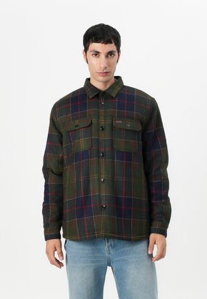 Groene en marineblauwe geruite shirtjack, met twee borstzakken, zwarte knopen en een kraag. Gemaakt van een gestructureerde, warme stof.