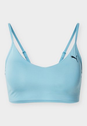 Helehall sinine spordirinnahoidja, millel on õhukesed reguleeritavad rihmad ja vasakul küljel väike must Puma logo.