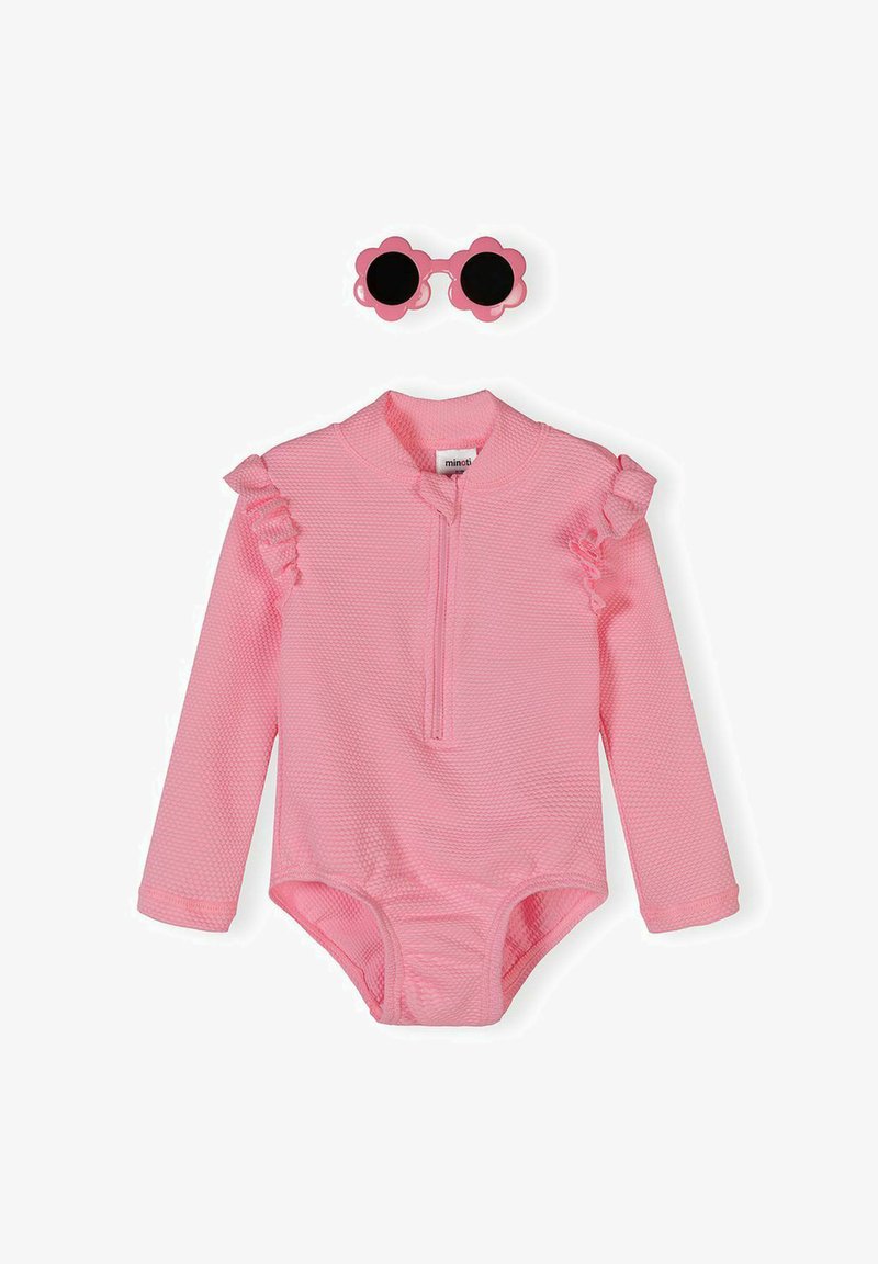 Pink textured long-sleeve baby romper with ruffled shoulders and half-zip front, paired with pink flower-shaped sunglasses with black lenses.