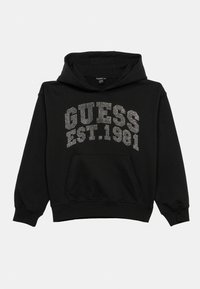 Hanorac negru din amestec de bumbac, cu buzunar frontal; „GUESS EST.1981” scris cu strasuri pe piept. Croială standard cu manșete ribbate.