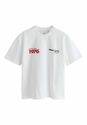 White cotton t-shirt featuring "Built to Thrill" and "GOLF GTI" graphics in red and black, with the year "1976" highlighted. Short sleeves.