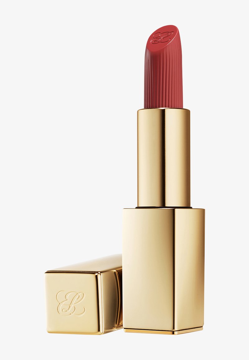 Red lipstick with ribbed texture and embossed initials, housed in a reflective gold square tube with matching cap beside it.