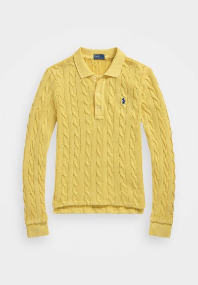 Žltý pletený polo svetrový top s dlhým rukávom a zúbkovo vzorom, golierom a tromi gombíkmi. Obsahuje malé modré logo na ľavej hrudi.