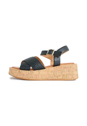 Black woven leather wedge sandal with a cork platform sole and an ankle strap featuring a gold buckle closure.
