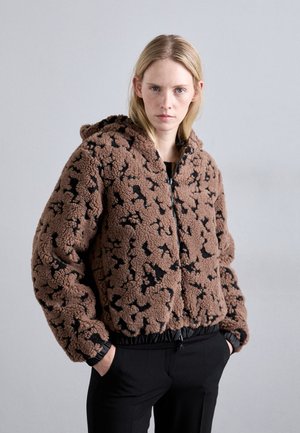 Brown fleece jacket with black abstract pattern, featuring a zip front, attached hood, and elastic cuffs and hem. Soft texture and relaxed fit.