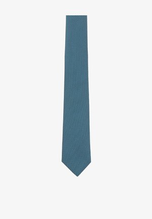 Teal tie made of woven fabric featuring a textured pattern with small white dots. Tapered end and smooth finish.