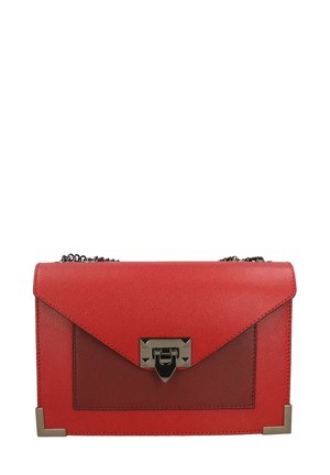 Red leather handbag with a textured finish, triangular flap, silver hardware, and chain strap. Features a transparent front panel and geometric accents.