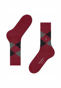 Calzini a rombi rossi e grigi con accenti neri; realizzati in un materiale elastico. Un piccolo logo è presente sulla suola.
