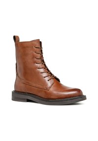 Bruine leren enkelboot met een ronde neus, vetersluiting en een dikke rubberen zool. Kenmerkt zich door stiksels en een trekstrip aan de hiel.