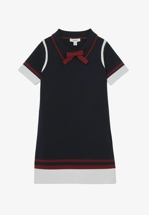 Marineblaues Kleid mit roten und weißen Akzenten. Es hat einen Kragen, kurze Ärmel und eine rote Schleife am Ausschnitt. Glatte Textur, schlichtes Design.